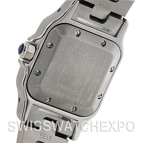 The image shows the back case of a Cartier Santos W20054D6 Women
s Stainless Steel Silver Dial W20054D6 Women
s Stainless Steel Silver Dial watch, including the engravings and part of the metal bracelet.