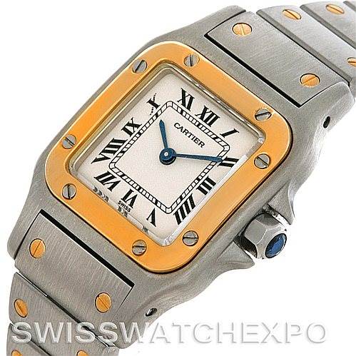 The image shows a Cartier Santos W20012C4 Women
s Stainless Steel Silver Dial W20012C4 Women
s Stainless Steel Silver Dial watch from a slight angle, featuring its face, bezel, and part of the bracelet.