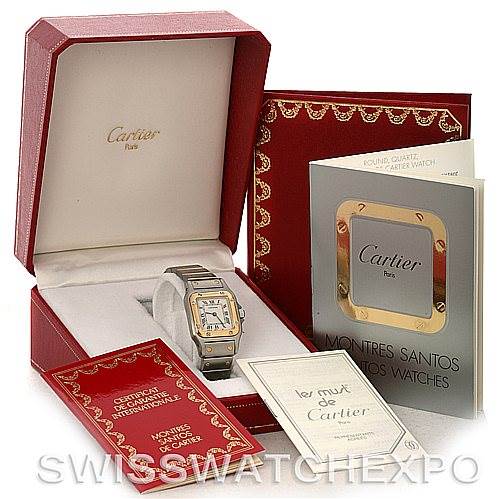 The image shows a Cartier Santos W20012C4 Women
s Stainless Steel Silver Dial W20012C4 Women
s Stainless Steel Silver Dial watch with its branded box, warranty card, information booklet, and certificates.