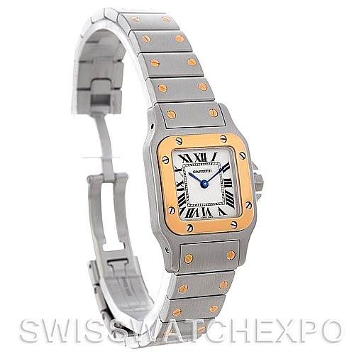 The image shows a Santos de Cartier watch from a three-quarter angle, highlighting the face, bracelet, and clasp.