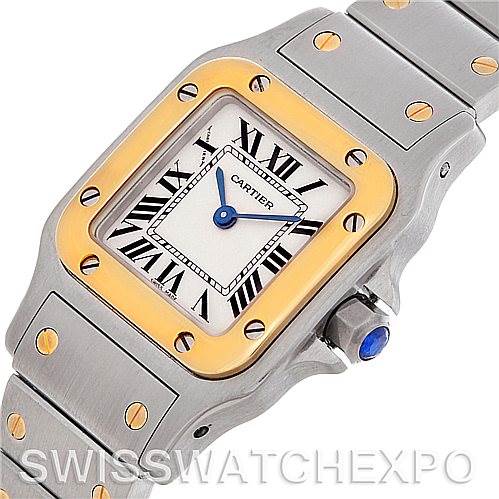 This image displays a Cartier Santos W20012C4 Women
s Stainless Steel Silver Dial W20012C4 Women
s Stainless Steel Silver Dial watch from an angled top-down view, highlighting the face, bezel, and part of the bracelet.