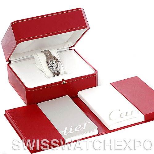 The image shows a Cartier Santos W20054D6 Women
s Stainless Steel Silver Dial W20054D6 Women
s Stainless Steel Silver Dial watch in a red presentation box with accompanying booklets and packaging materials.