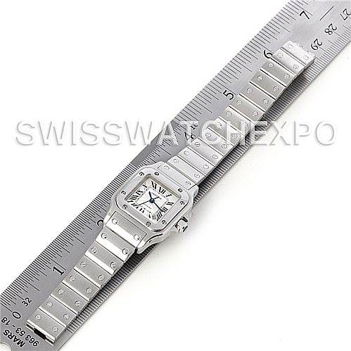 The image shows a top-down view of a Cartier Santos W20054D6 Women
s Stainless Steel Silver Dial W20054D6 Women
s Stainless Steel Silver Dial watch placed alongside a ruler to indicate its length.