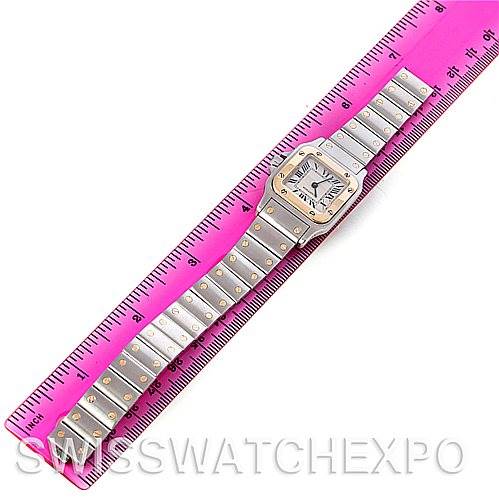 The Cartier Santos W20012C4 Women
s Stainless Steel Silver Dial W20012C4 Women
s Stainless Steel Silver Dial watch is shown fully extended next to a pink ruler for size reference.
