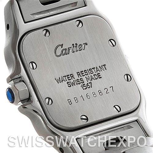 This image shows the back case and part of the bracelet of a Cartier Santos W20012C4 Women
s Stainless Steel Silver Dial W20012C4 Women
s Stainless Steel Silver Dial watch, highlighting the inscriptions and screws.