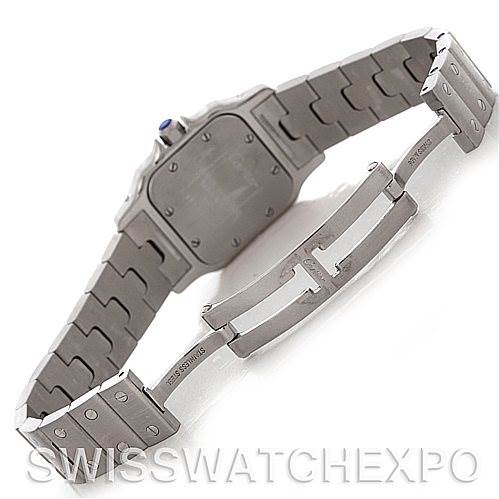 This image shows the backside and clasp of the Santos model watch by Cartier, highlighting its metal bracelet and deployment buckle.