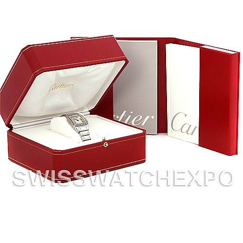 The image shows a Cartier Santos W20054D6 Women
s Stainless Steel Silver Dial W20054D6 Women
s Stainless Steel Silver Dial watch inside its red presentation box, with accompanying documents beside it.