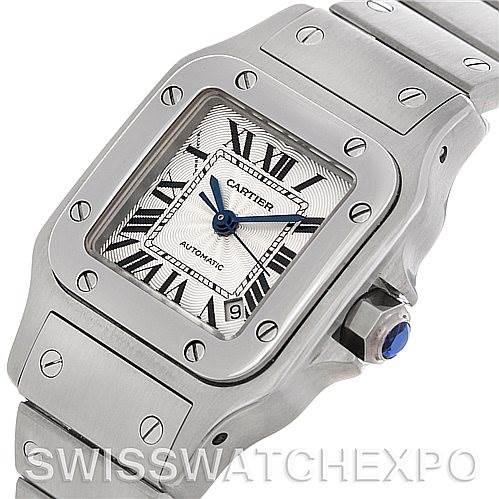 The image shows a Cartier Santos W20054D6 Women
s Stainless Steel Silver Dial W20054D6 Women
s Stainless Steel Silver Dial watch from an angled perspective highlighting its face, bezel, and part of the bracelet.