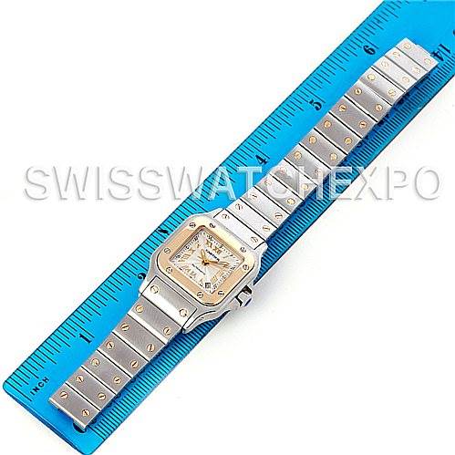 This image shows a Cartier Santos W20057C4 Women's Stainless Steel Silver Dial W20057C4 Women's Stainless Steel Silver Dial watch laid flat, displaying the face, bezel, and bracelet, measured against a blue ruler.