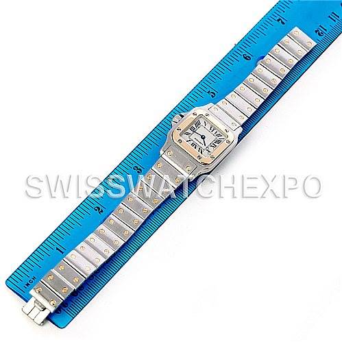 The image shows a full-length view of a Cartier Santos W20012C4 Women
s Stainless Steel Silver Dial W20012C4 Women
s Stainless Steel Silver Dial watch against a blue ruler for scale.