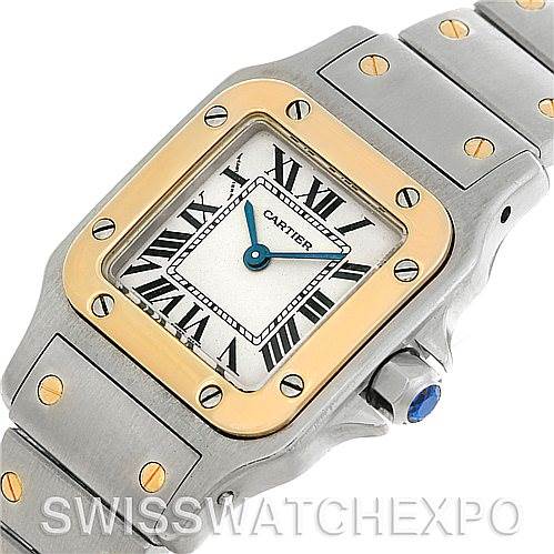 This image shows a close-up of a Cartier Santos W20012C4 Women
s Stainless Steel Silver Dial W20012C4 Women
s Stainless Steel Silver Dial watch, highlighting its face, bezel, and part of the strap at an oblique angle.