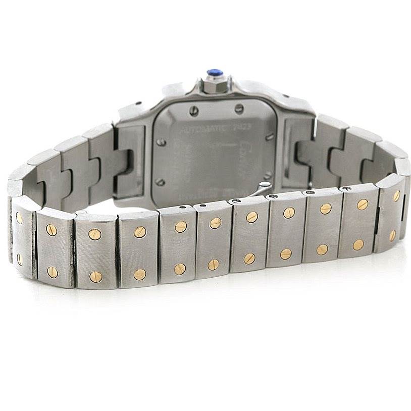 The image shows the back case and bracelet of a Santos model watch by Cartier, featuring its distinctive two-tone metal links.