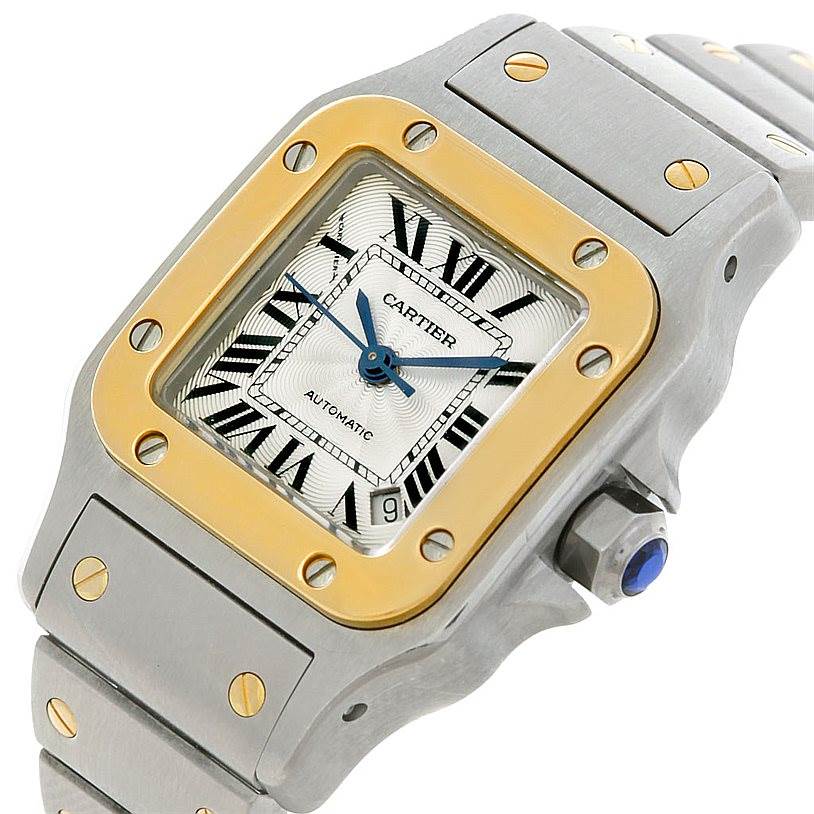 The image shows a close-up angled view of the Cartier Santos W20045C4 Women
s Stainless Steel Silver Dial W20045C4 Women
s Stainless Steel Silver Dial watch face and part of the bracelet, highlighting its bezel and crown.