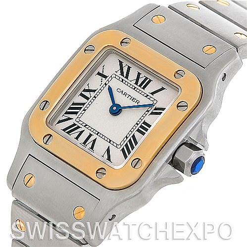 The image shows a close-up view of the Cartier Santos W20012C4 Women's Stainless Steel Silver Dial W20012C4 Women's Stainless Steel Silver Dial watch, highlighting its face, bezel, crown, and part of the bracelet.