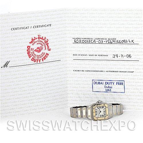 The image shows the front view of a Cartier Santos W20012C4 Women's Stainless Steel Silver Dial W20012C4 Women's Stainless Steel Silver Dial watch with its certificate in the background.