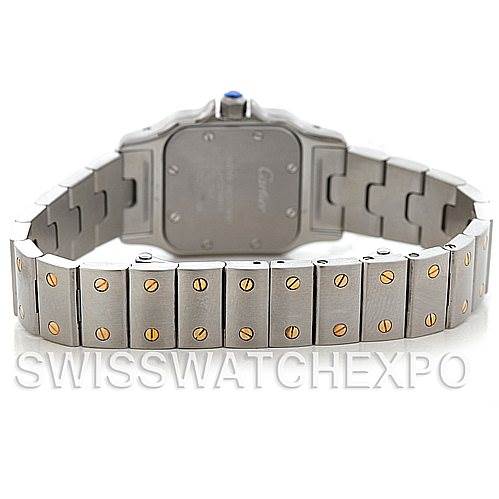The image shows the back case and bracelet of a Santos model by Cartier, focusing on the metal band with gold screws.