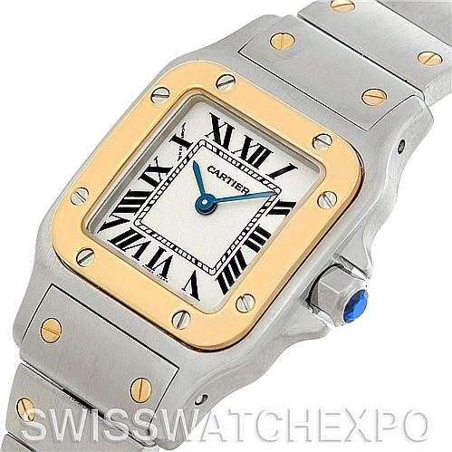 This image shows a close-up of the face and part of the strap of a Cartier Santos W20012C4 Women
s Stainless Steel Silver Dial W20012C4 Women
s Stainless Steel Silver Dial watch, highlighting its square dial and gold accents.