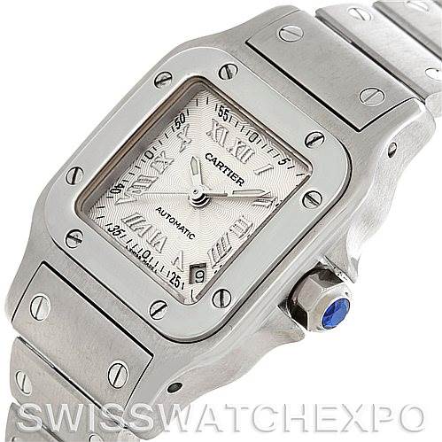 This image shows a close-up angled view of the Santos model by Cartier, highlighting the dial, bezel, and part of the bracelet.