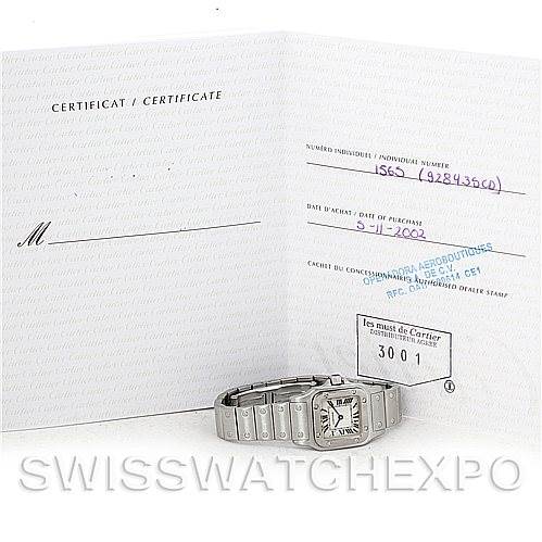 The image shows a Cartier Santos W20056D6 Women
s Stainless Steel Silver Dial W20056D6 Women
s Stainless Steel Silver Dial watch placed in front of its certification paperwork.