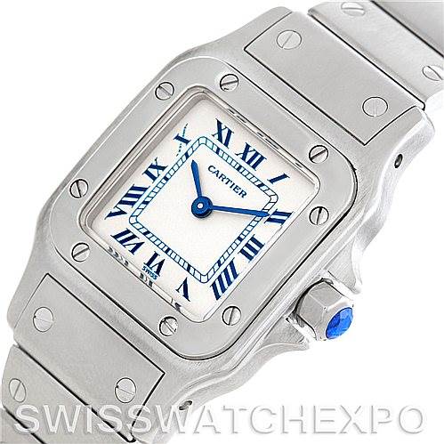 This image shows a close-up of the Cartier Santos 1565 Women
s Stainless Steel Silver Dial 1565 Women
s Stainless Steel Silver Dial watch, highlighting the face, bezel, crown, and part of the bracelet.