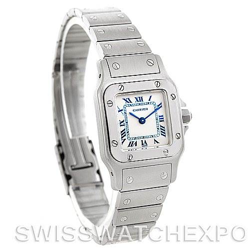 The image shows a Santos model by Cartier with a square face, Roman numerals, and a stainless steel bracelet at a three-quarter angle.