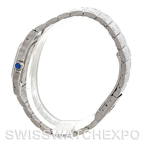 The image shows a Cartier Santos 1565 Women
s Stainless Steel Silver Dial 1565 Women
s Stainless Steel Silver Dial watch from a side angle, highlighting its stainless steel band and the blue cabochon on the crown.