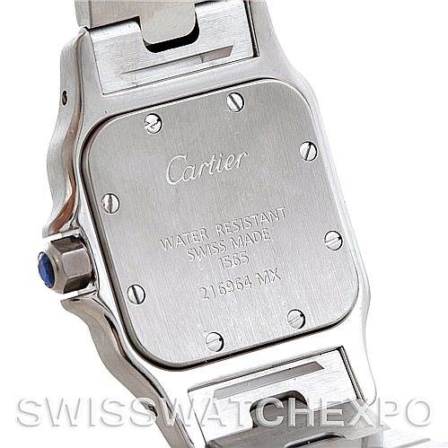 The image shows the back case of a Cartier Santos W20056D6 Women
s Stainless Steel Silver Dial W20056D6 Women
s Stainless Steel Silver Dial watch with "Cartier" engraved, various specifications, and part of the strap.