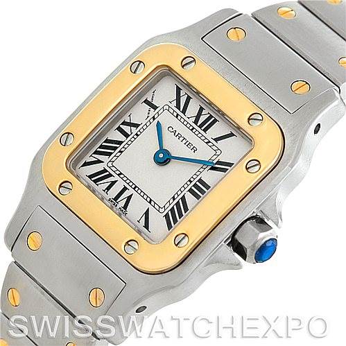 This image shows a close-up angle of the face and part of the band of a Santos model watch by Cartier.