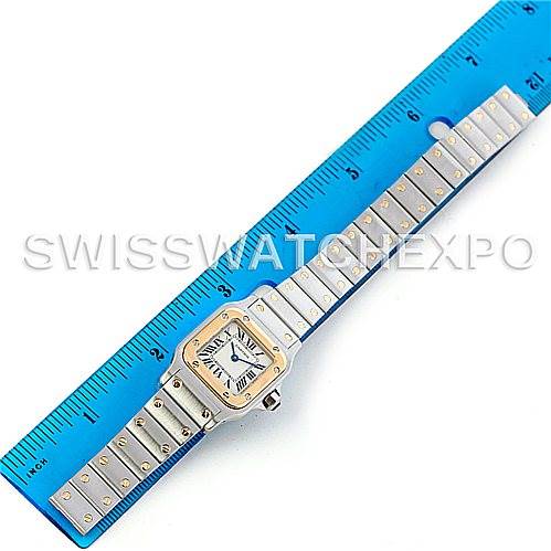 The image shows a top-down view of a Cartier Santos W20012C4 Women's Stainless Steel Silver Dial W20012C4 Women's Stainless Steel Silver Dial watch laid alongside a blue ruler for scale.