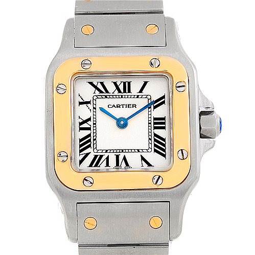 This image shows a frontal view of a Cartier Santos W20012C4 Women
s Stainless Steel Silver Dial W20012C4 Women
s Stainless Steel Silver Dial watch, highlighting its Roman numeral dial, gold bezel, and two-tone metal bracelet.