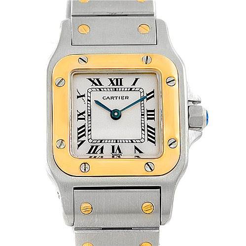 The image shows the face and part of the bracelet of a Cartier Santos W20012C4 Women's Stainless Steel Silver Dial W20012C4 Women's Stainless Steel Silver Dial watch, highlighting its square dial, Roman numerals, and gold accents.