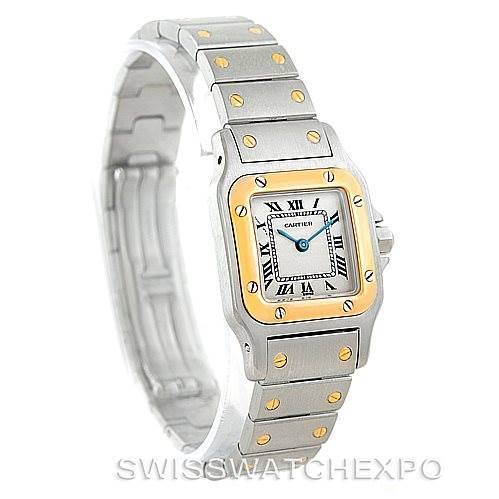 The image shows the Santos model by Cartier at a slight angle, highlighting the dial, bracelet, and bezel.