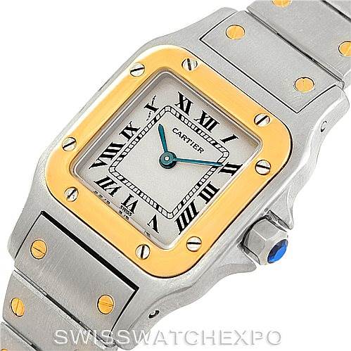 The image shows a close-up of a Cartier Santos W20012C4 Women's Stainless Steel Silver Dial W20012C4 Women's Stainless Steel Silver Dial watch, highlighting the dial, bezel, and part of the bracelet.