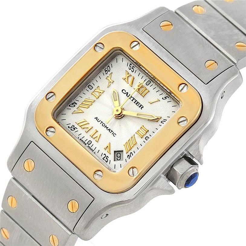 The image shows a close-up of the Cartier Santos W20057C4 Women
s Stainless Steel Silver Dial W20057C4 Women
s Stainless Steel Silver Dial watch face and part of its bracelet, displaying its square bezel and Roman numeral markers.
