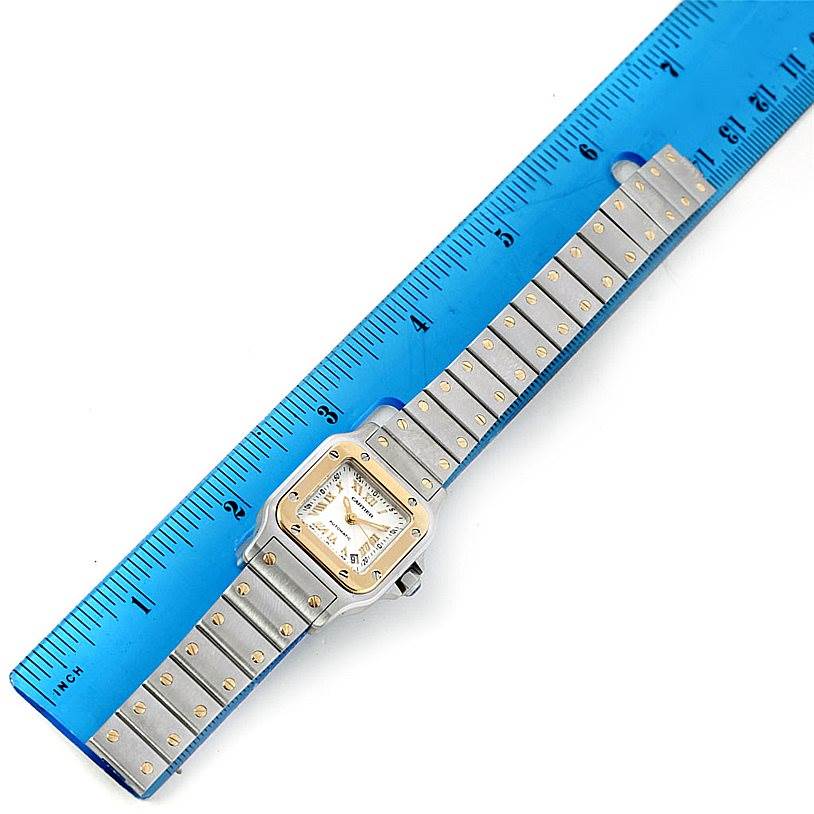 The image shows a top view of a Cartier Santos W20057C4 Women
s Stainless Steel Silver Dial W20057C4 Women
s Stainless Steel Silver Dial watch, including the square face, bezel, and metal strap.