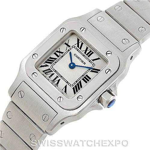The image shows a close-up angle of the Cartier Santos W20056D6 Women
s Stainless Steel Silver Dial W20056D6 Women
s Stainless Steel Silver Dial watch, highlighting its square face, Roman numeral dial, and part of the metal bracelet.