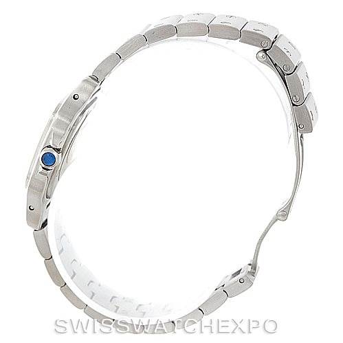 The image shows a side profile of the Cartier Santos W20056D6 Women
s Stainless Steel Silver Dial W20056D6 Women
s Stainless Steel Silver Dial watch, highlighting its bracelet and the blue cabochon crown.