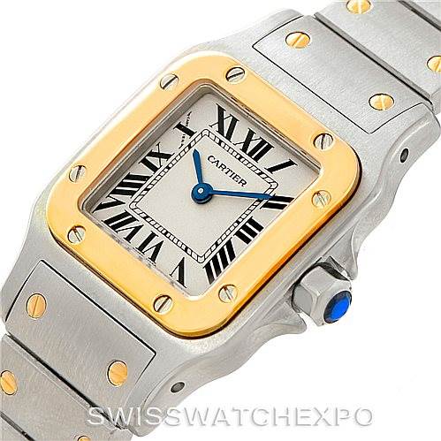 The image shows the face and part of the bracelet of a Cartier Santos W20012C4 Women's Stainless Steel Silver Dial W20012C4 Women's Stainless Steel Silver Dial watch, highlighting its square dial and two-tone design.