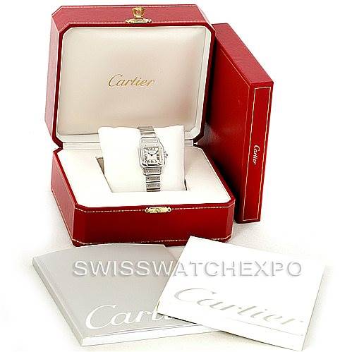 The image shows a Cartier Santos W20056D6 Women
s Stainless Steel Silver Dial W20056D6 Women
s Stainless Steel Silver Dial watch displayed in an open red box, with additional booklets placed nearby.