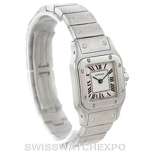 The Cartier Santos W20056D6 Women
s Stainless Steel Silver Dial W20056D6 Women
s Stainless Steel Silver Dial watch is shown at a three-quarter angle, displaying its face, bezel, and metal bracelet.