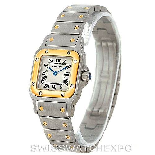 The Santos watch by Cartier is shown at an angled view, highlighting the square face, bracelet, and gold screws.