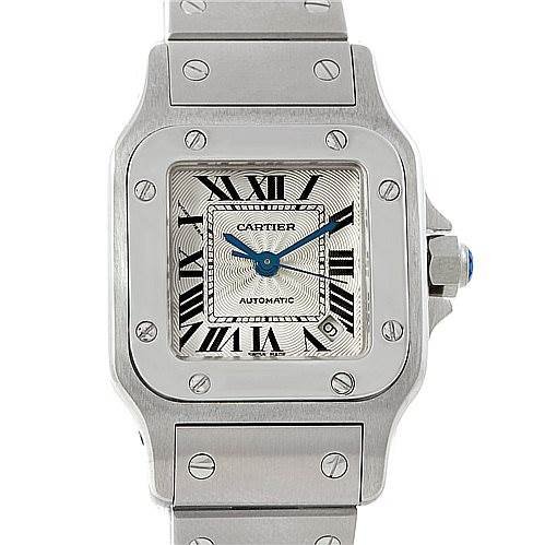 The image displays a frontal view of the Cartier Santos W20054D6 Women
s Stainless Steel Silver Dial W20054D6 Women
s Stainless Steel Silver Dial watch, showcasing its face, bezel, crown, and part of the bracelet.