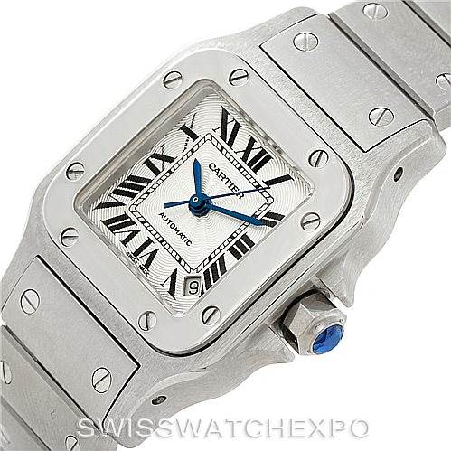 The image shows a close-up of a Cartier Santos W20054D6 Women
s Stainless Steel Silver Dial W20054D6 Women
s Stainless Steel Silver Dial watch, highlighting the face, bezel, and section of the bracelet, viewed from an angled perspective.