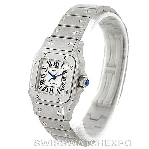 The Cartier Santos W20054D6 Women
s Stainless Steel Silver Dial W20054D6 Women
s Stainless Steel Silver Dial watch is shown at a three-quarter angle, displaying its face, bezel, crown, and bracelet.