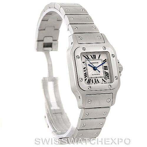 This image shows a Cartier Santos W20054D6 Women
s Stainless Steel Silver Dial W20054D6 Women
s Stainless Steel Silver Dial watch at an angle displaying the face, bezel, and part of the bracelet and clasp.