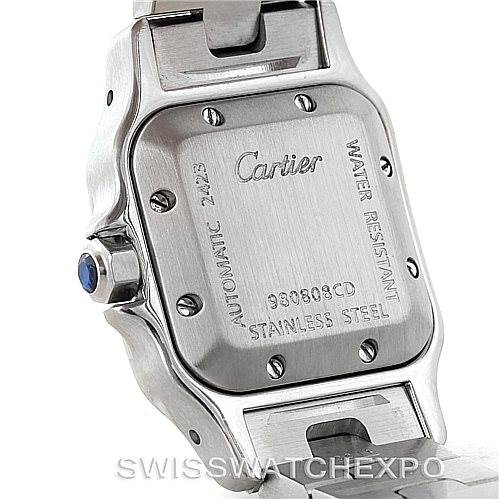 The image shows the back case of a Cartier Santos W20054D6 Women
s Stainless Steel Silver Dial W20054D6 Women
s Stainless Steel Silver Dial watch, highlighting the engravings and the stainless steel material.