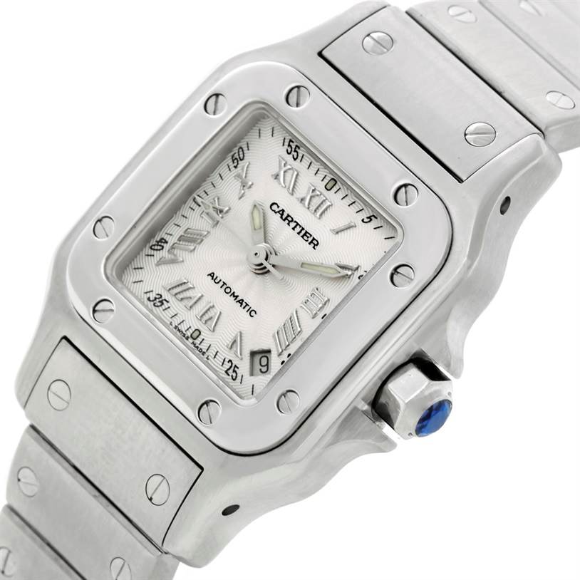 The Cartier Santos W20044D6 Women
s Stainless Steel Silver Dial W20044D6 Women
s Stainless Steel Silver Dial watch is shown from an angled view, highlighting its dial, bezel, crown, and part of its bracelet.