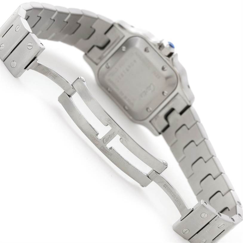 This image shows the back of the Santos model by Cartier and its partially opened stainless steel bracelet clasp.