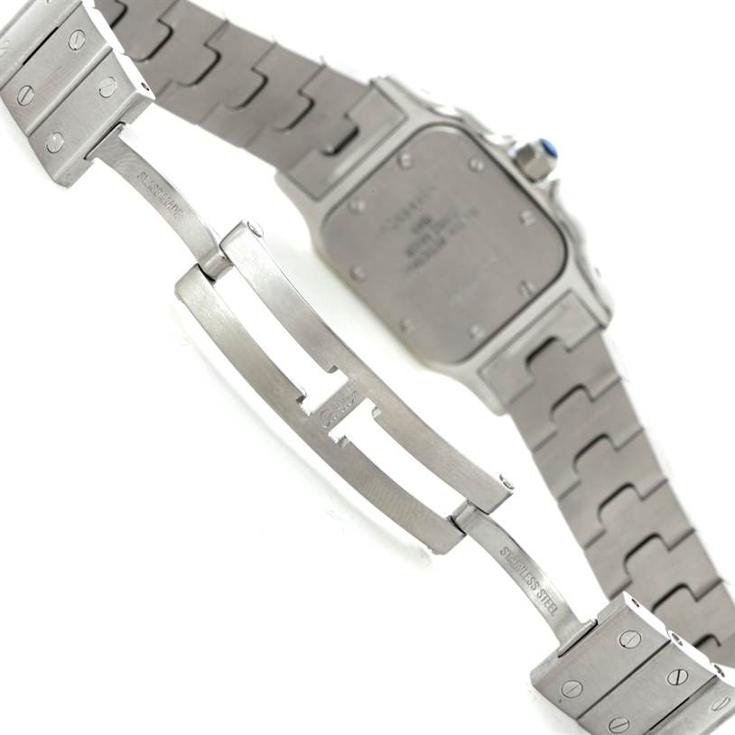 This image shows the back of a stainless steel Santos model by Cartier, including the case back and part of the bracelet and clasp.