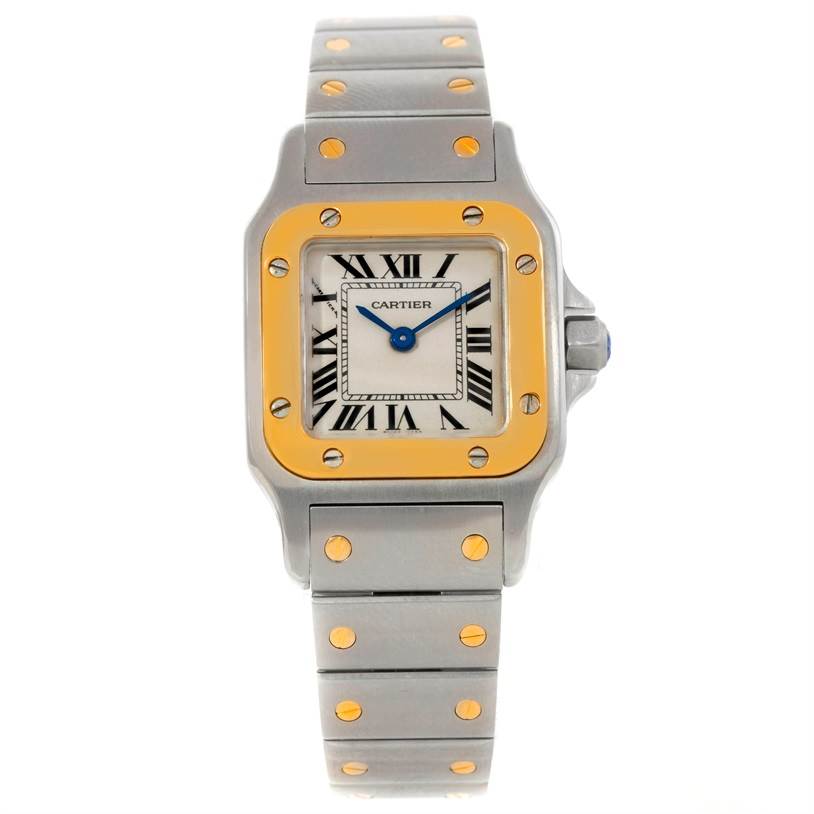 The Cartier Santos W20012C4 Women
s Stainless Steel Silver Dial W20012C4 Women
s Stainless Steel Silver Dial watch is shown from a top-down angle, highlighting its square face, stainless steel and gold bezel, and bracelet.